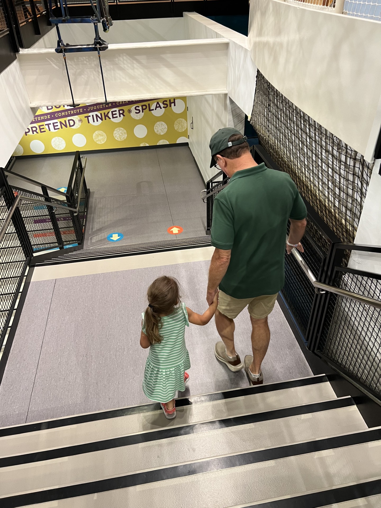 Father and child walking down stairs